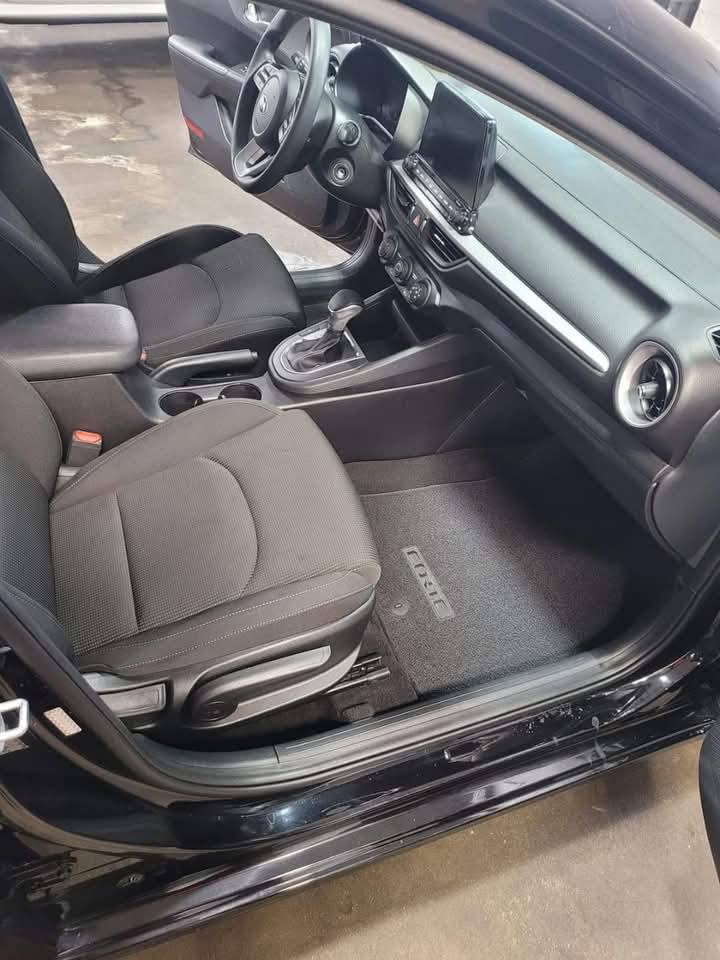 Black sedan cup holders and console — cleaned