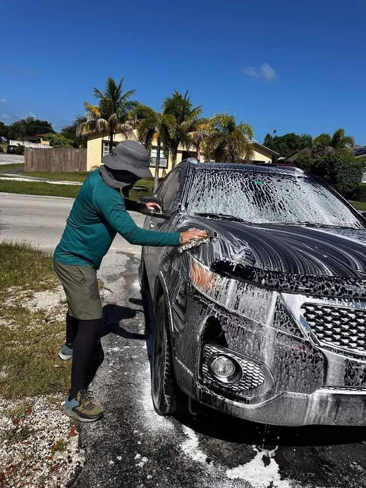 SUV being hand-washed with foam — before